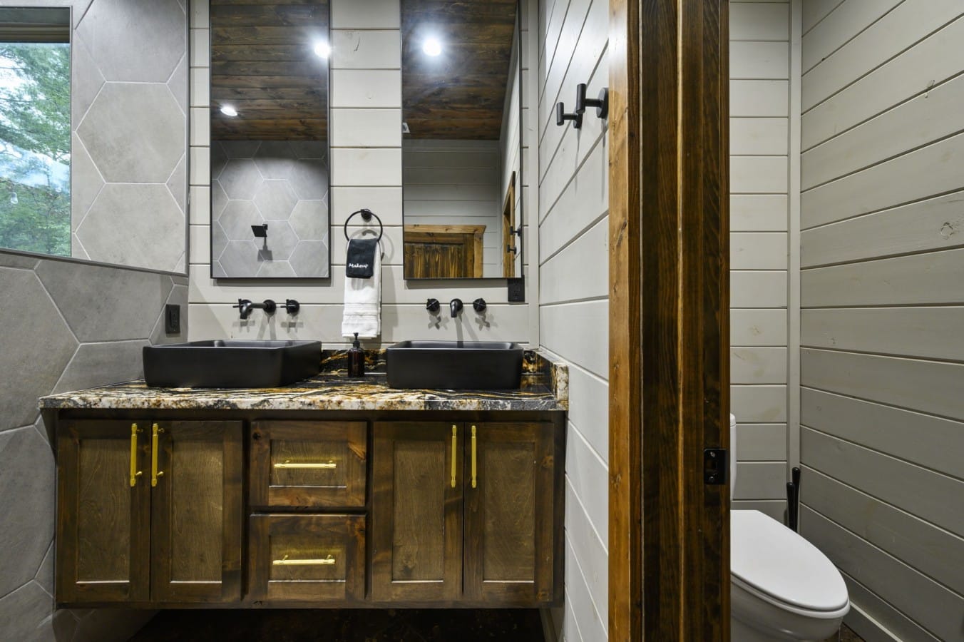 Dramatic granite and a barn door make this bathroom a design standout.