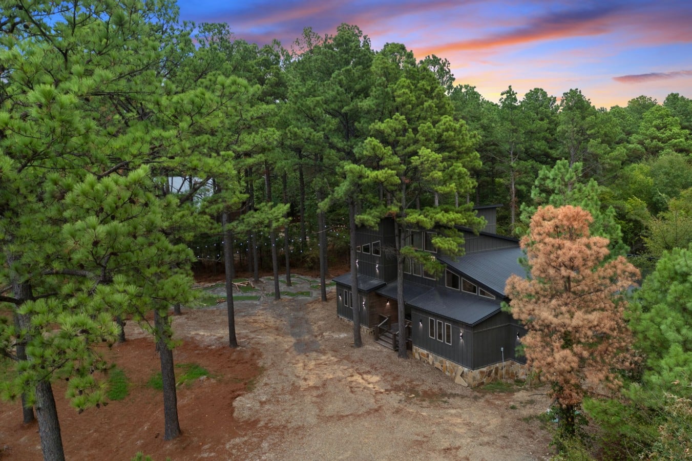 Your stunning mountain escape glows magically against a sunset sky.