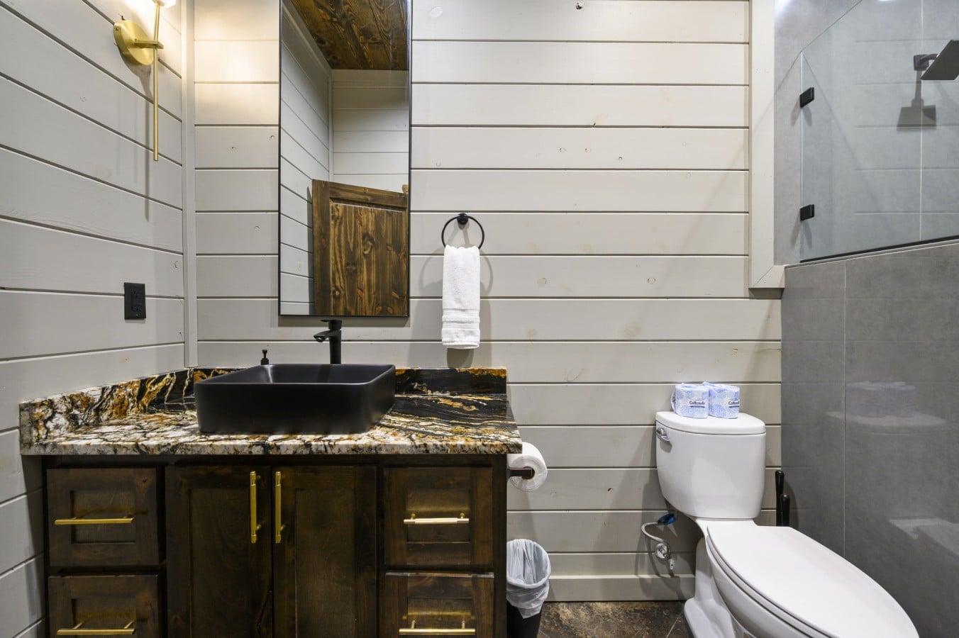 Pamper yourself in a spa-worthy bathroom with marble vanity and glass shower.