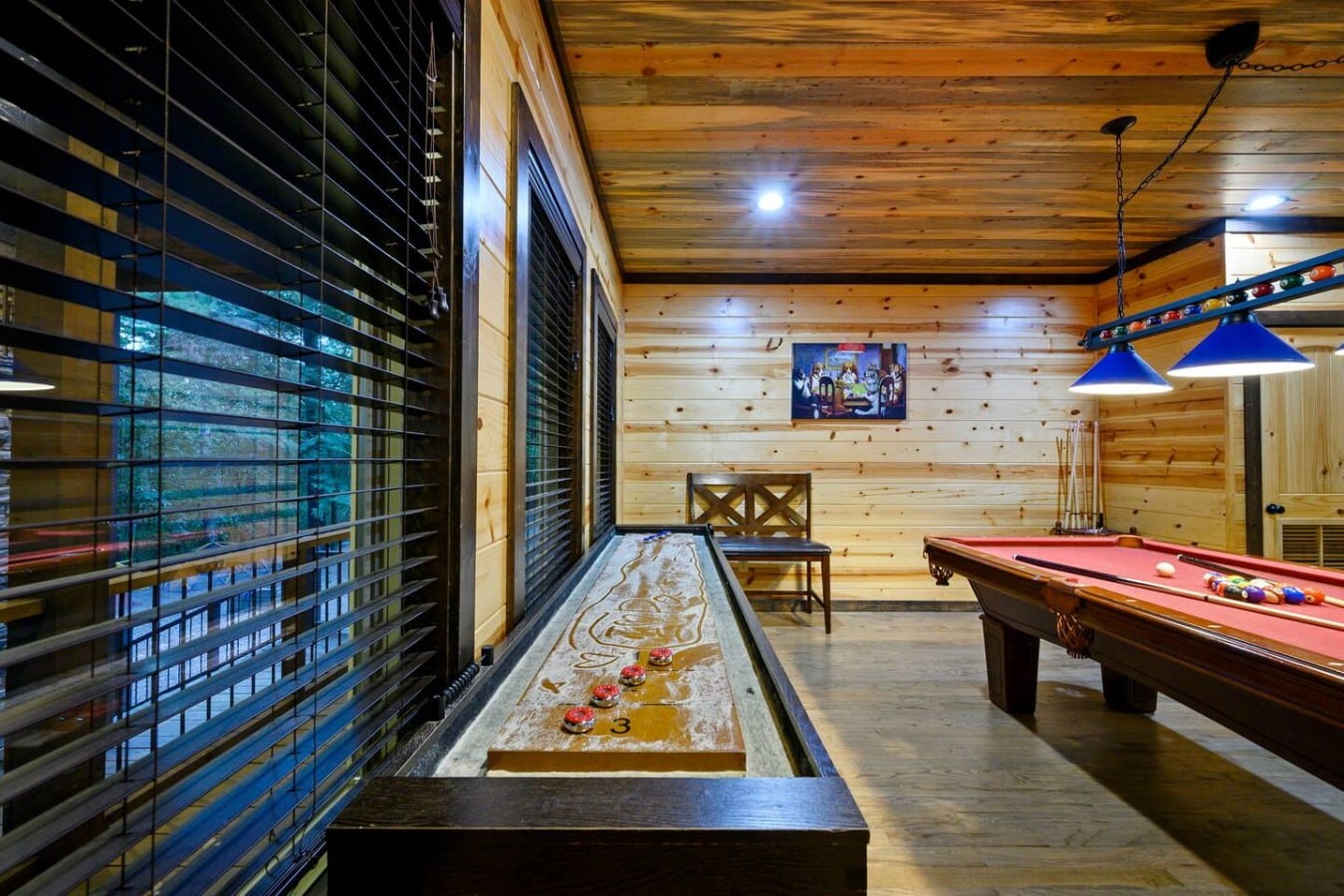 Shuffleboard, pool, and cabin art keep the game room buzzing all night long.