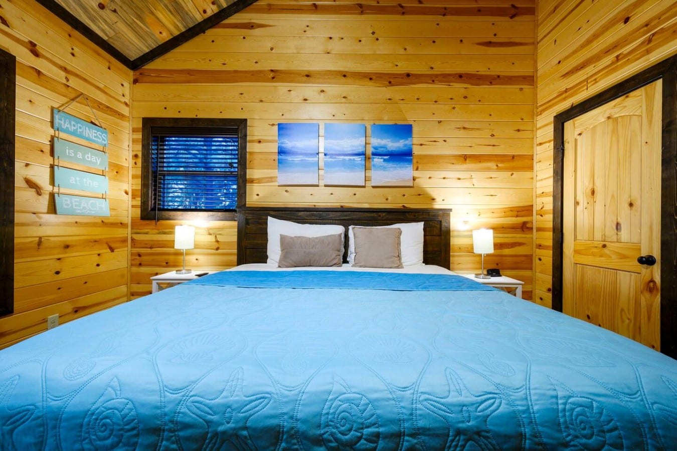 Fall asleep wrapped in nautical blue inside this warm, beautifully lit king bedroom.