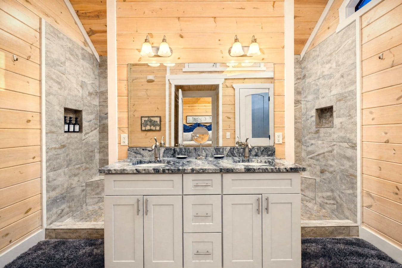 Two separate walk-in showers flank a grand double vanity — no waiting, ever.