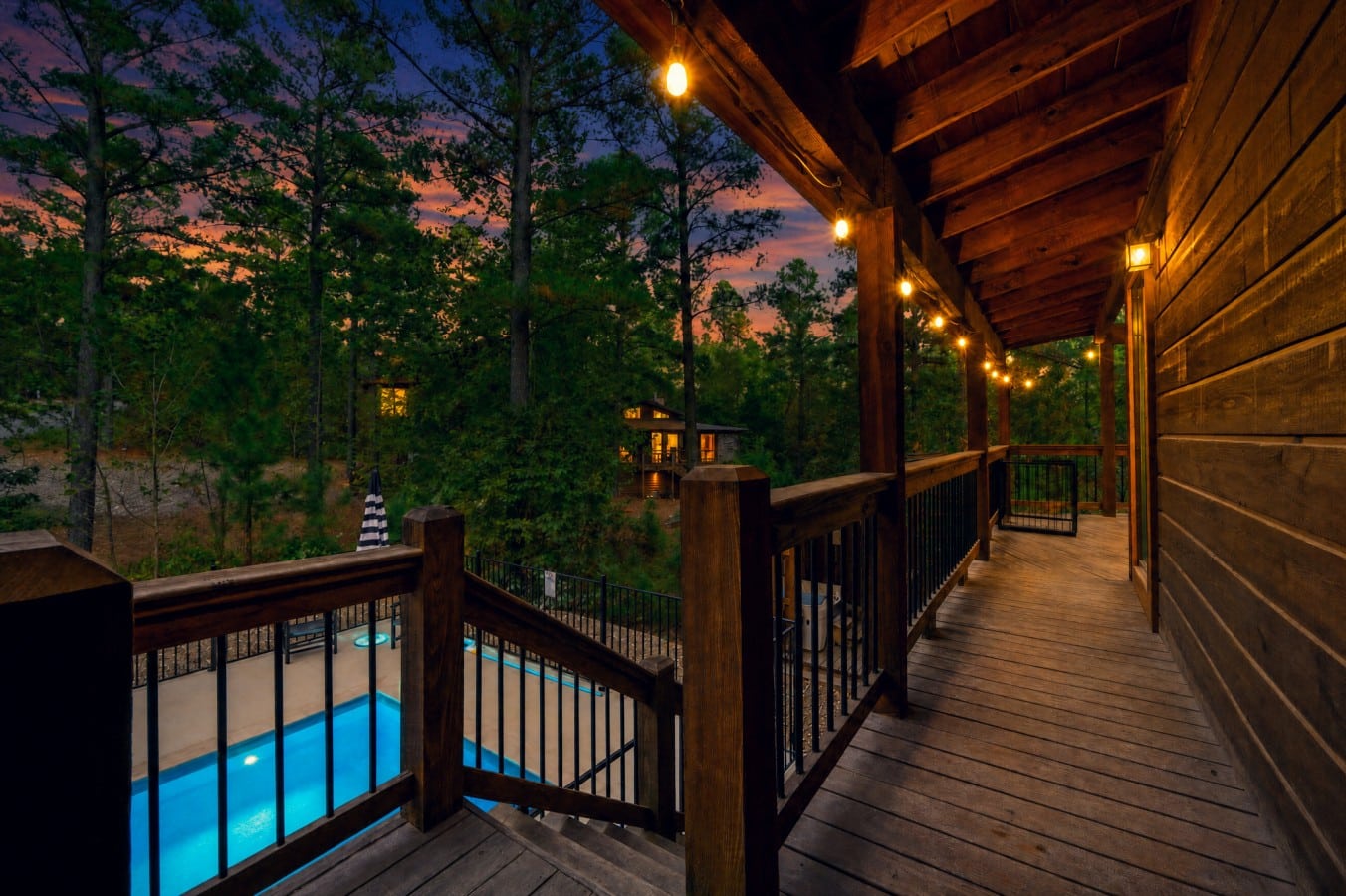 Look down from the deck and watch the pool shimmer gold beneath a fading sky.