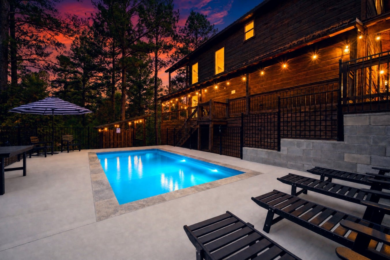 Electric blue water meets a pink-purple sky in a pool view that stops you cold.