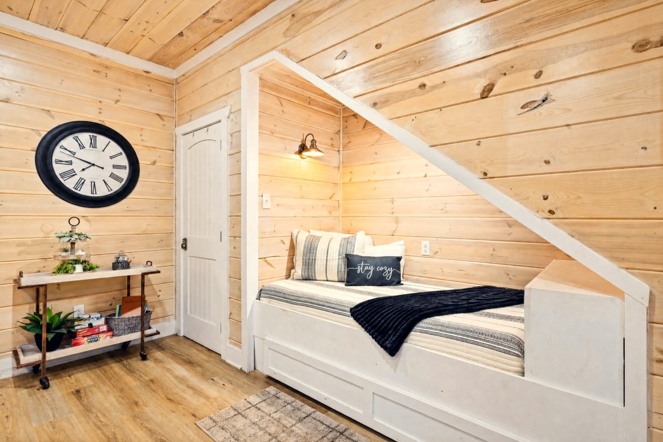 Little ones will love their own cozy staircase nook built just for sweet cabin dreams.