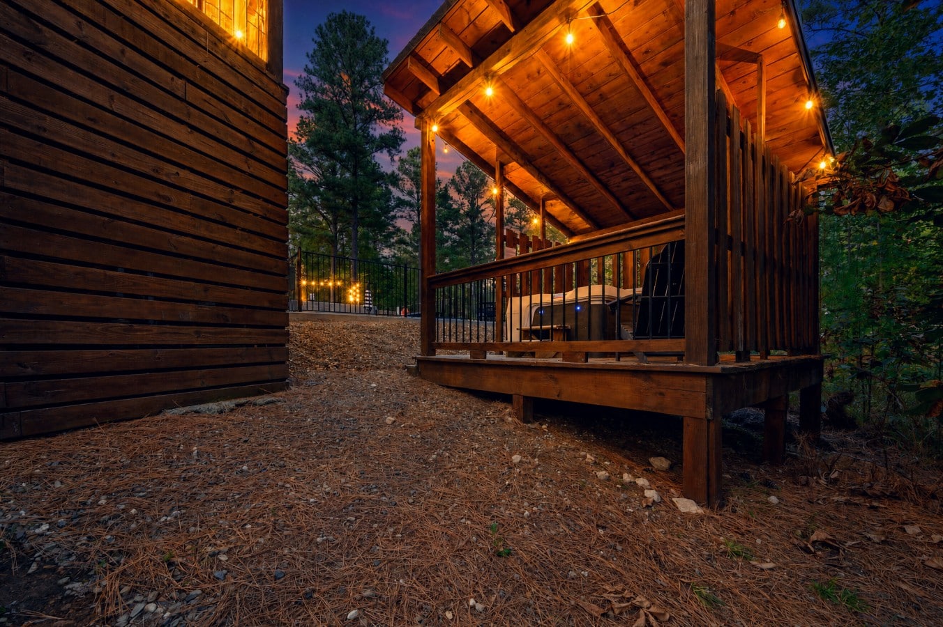 String lights, hot tub steam, and a purple sky — your evenings here are unforgettable.
