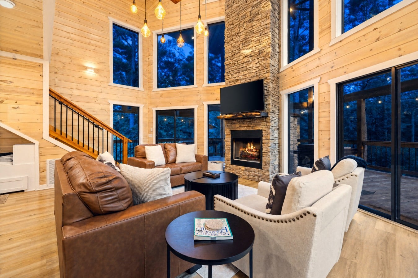 Floor-to-ceiling windows pull the twilight forest inside every time the fire roars to life.