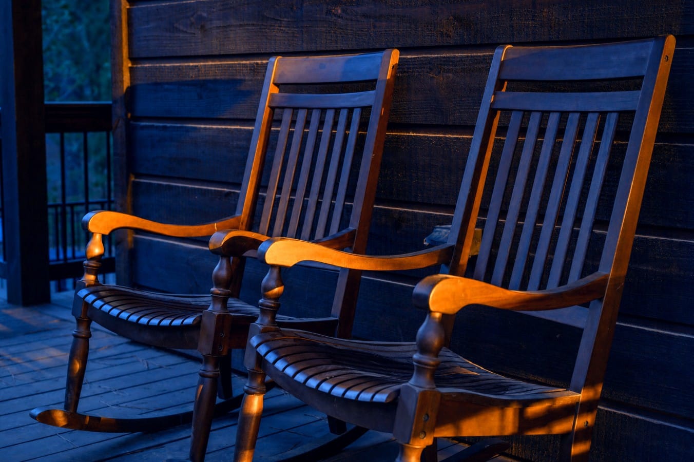 Two rocking chairs, golden light, and nowhere you'd rather be at dusk.