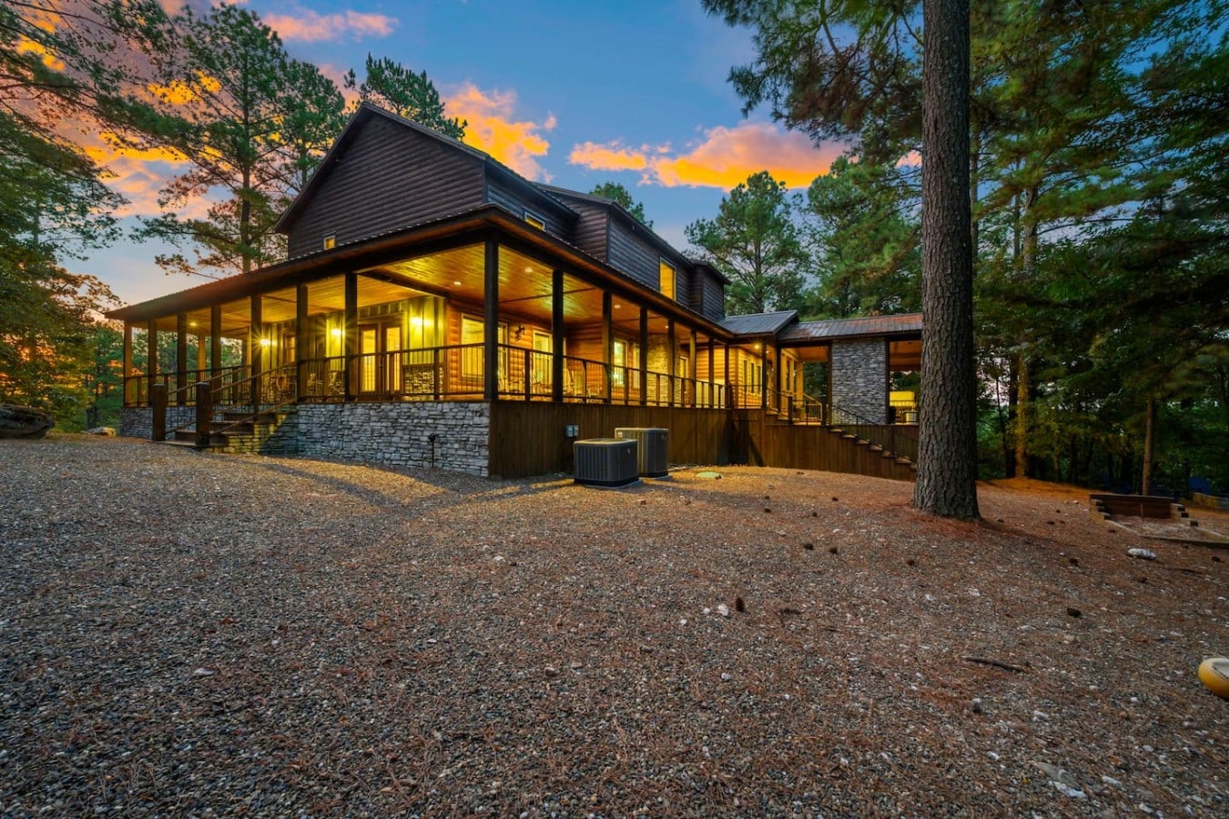 The whole family gathers on this sweeping porch as the sky bursts with color.