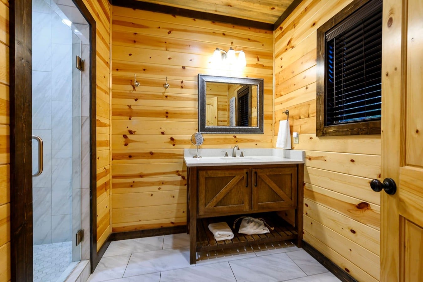 A glass-door shower and barn-wood vanity bring rustic charm to your daily refresh.