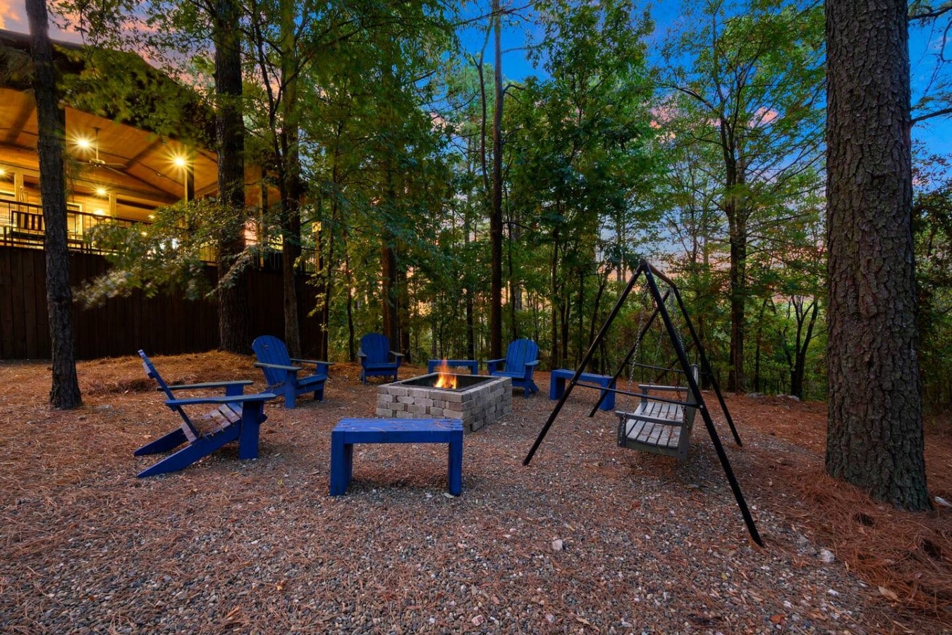 Evenings come alive around the fire pit, where Adirondack chairs and swinging seats await.