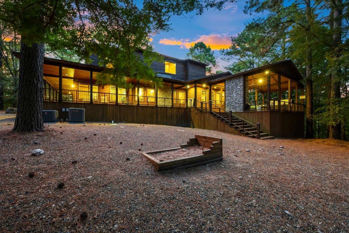 Picture yourself on this glowing wraparound deck as orange light floods the pines.