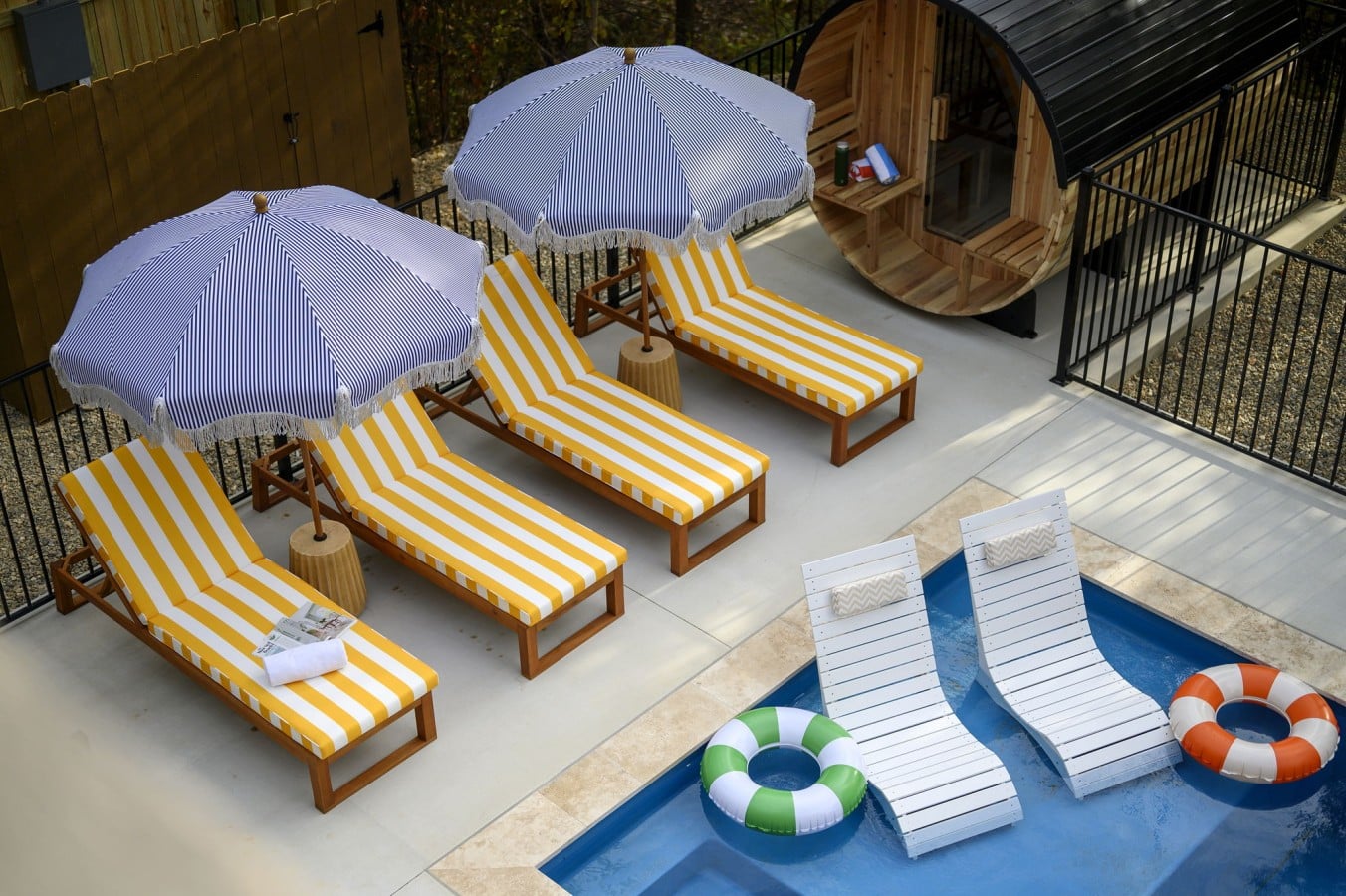 Your own resort-style oasis awaits, complete with floats, loungers, umbrellas, and a cedar sauna.