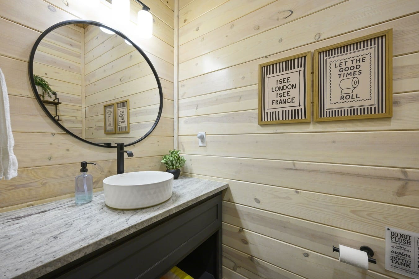 Even the guest bath has charm — shiplap walls and playful art keep spirits high.