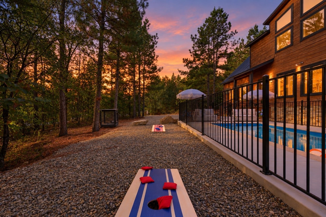 Cornhole at sunset beside the pool — this is what a perfect Broken Bow evening looks like.