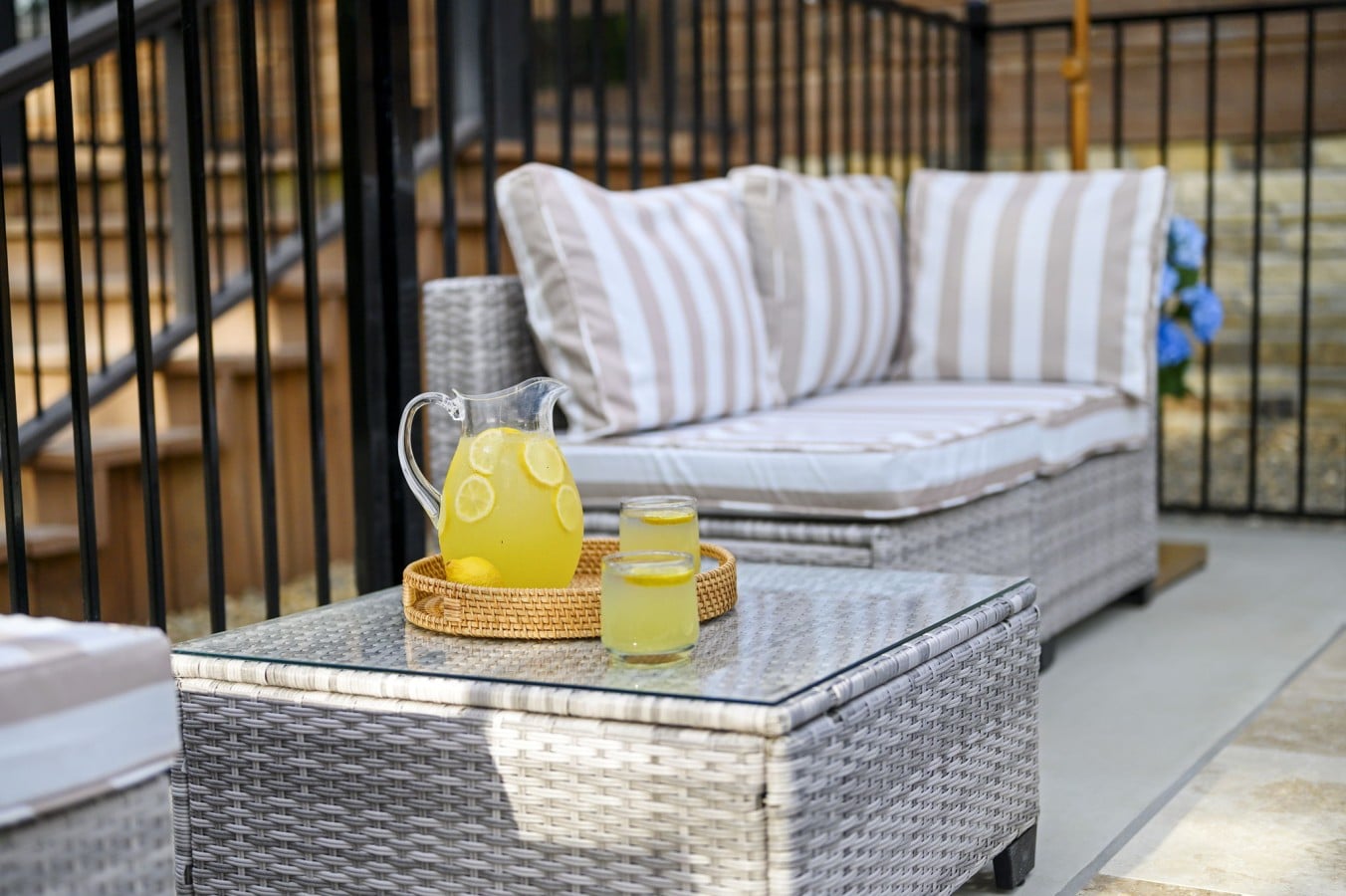 Fresh-poured lemonade on a rattan tray — because your poolside afternoons deserve this kind of ease.