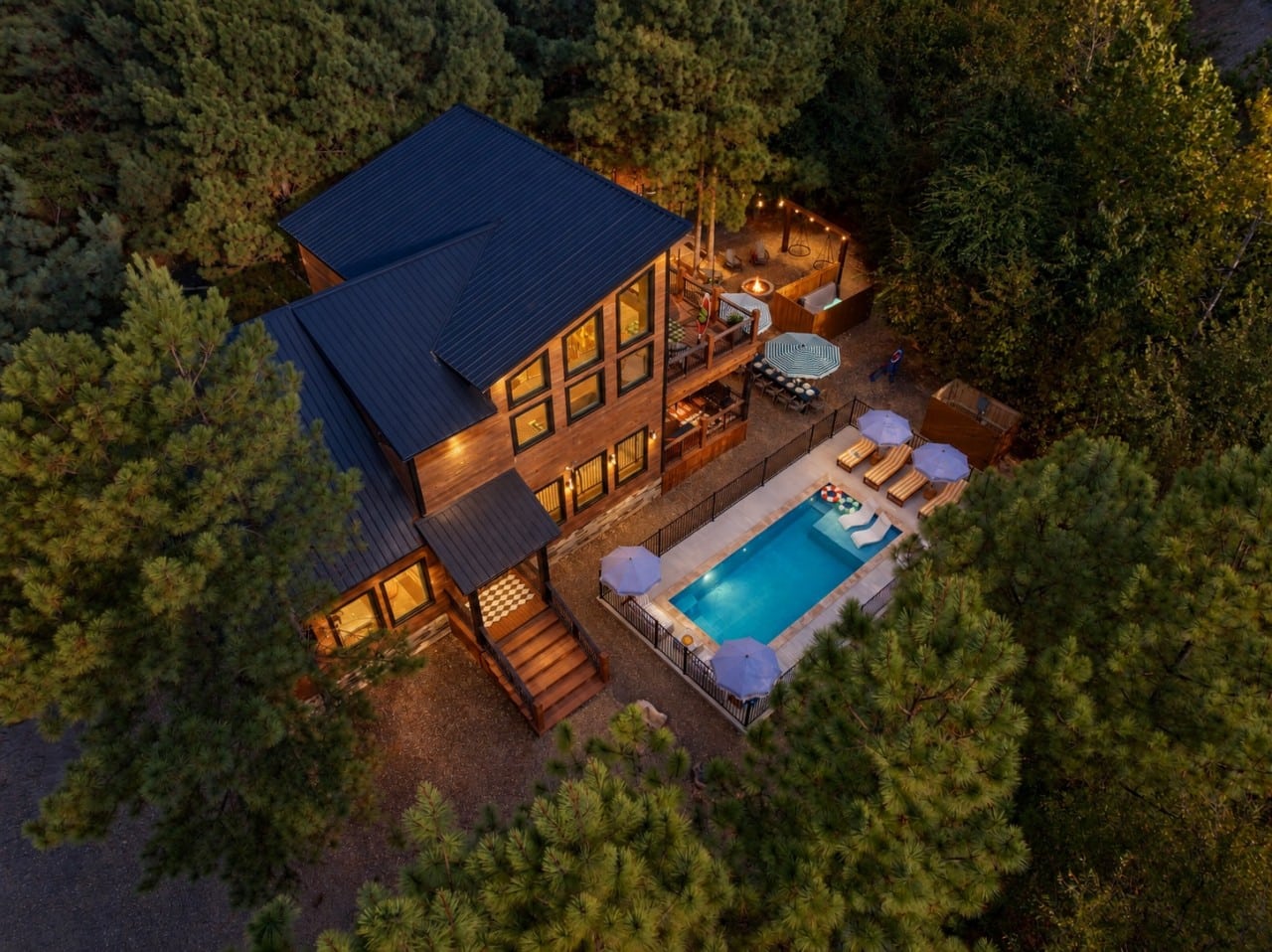Every luxury you'd want — pool, hot tub, fire pit — all yours under the pines.