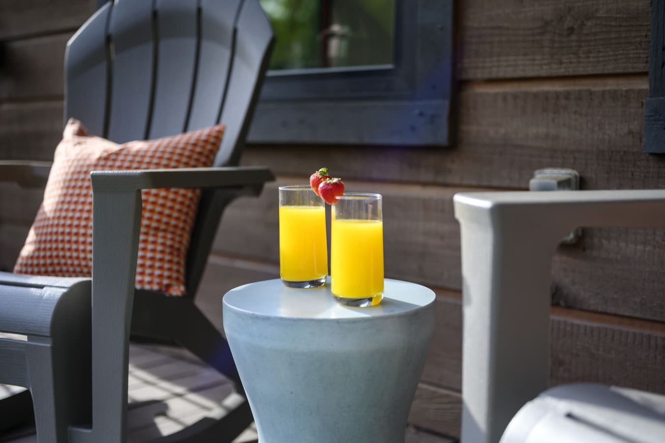 Start your morning right with fresh OJ and strawberries in an Adirondack chair on the deck.