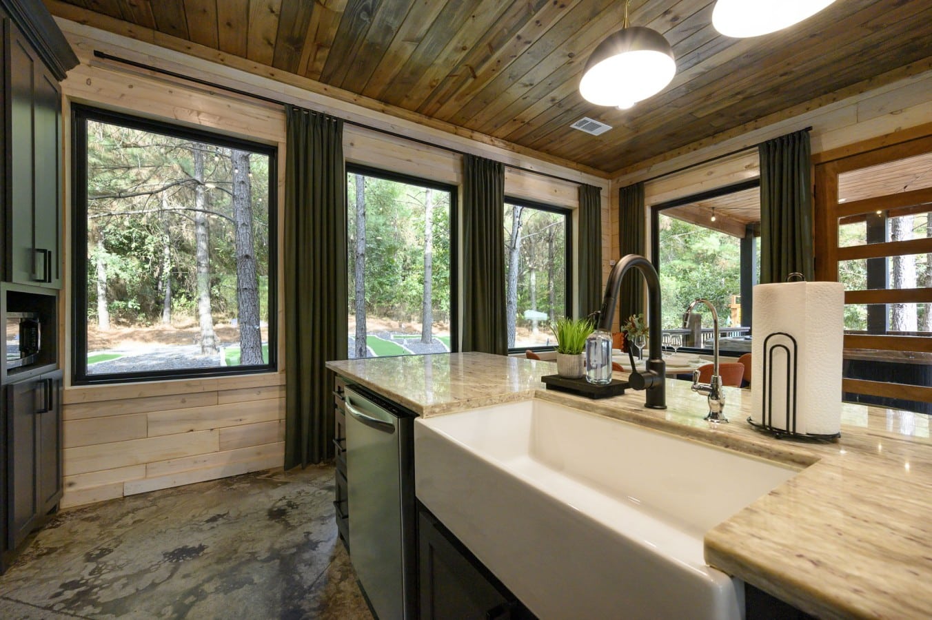 Wash up while soaking in pine forest views through oversized windows above the farmhouse sink.