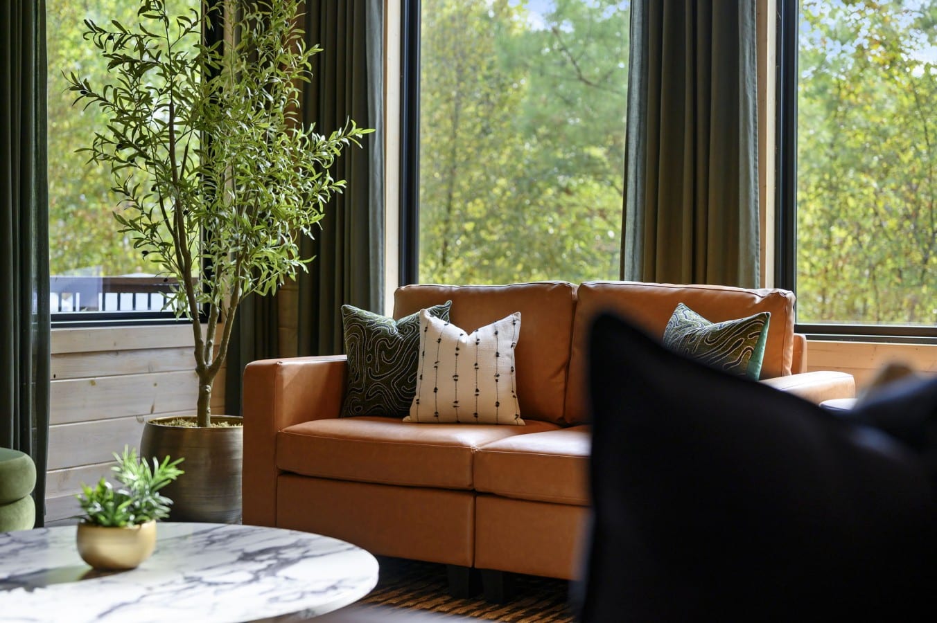 Sink into the loveseat with a book while a living wall of pines fills every window.