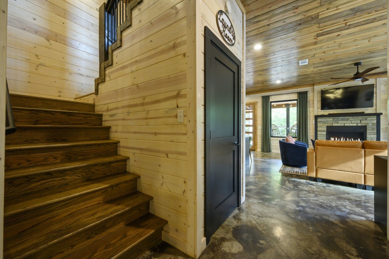 Everything is within easy reach — laundry, the staircase, and the fireplace waiting just around the
