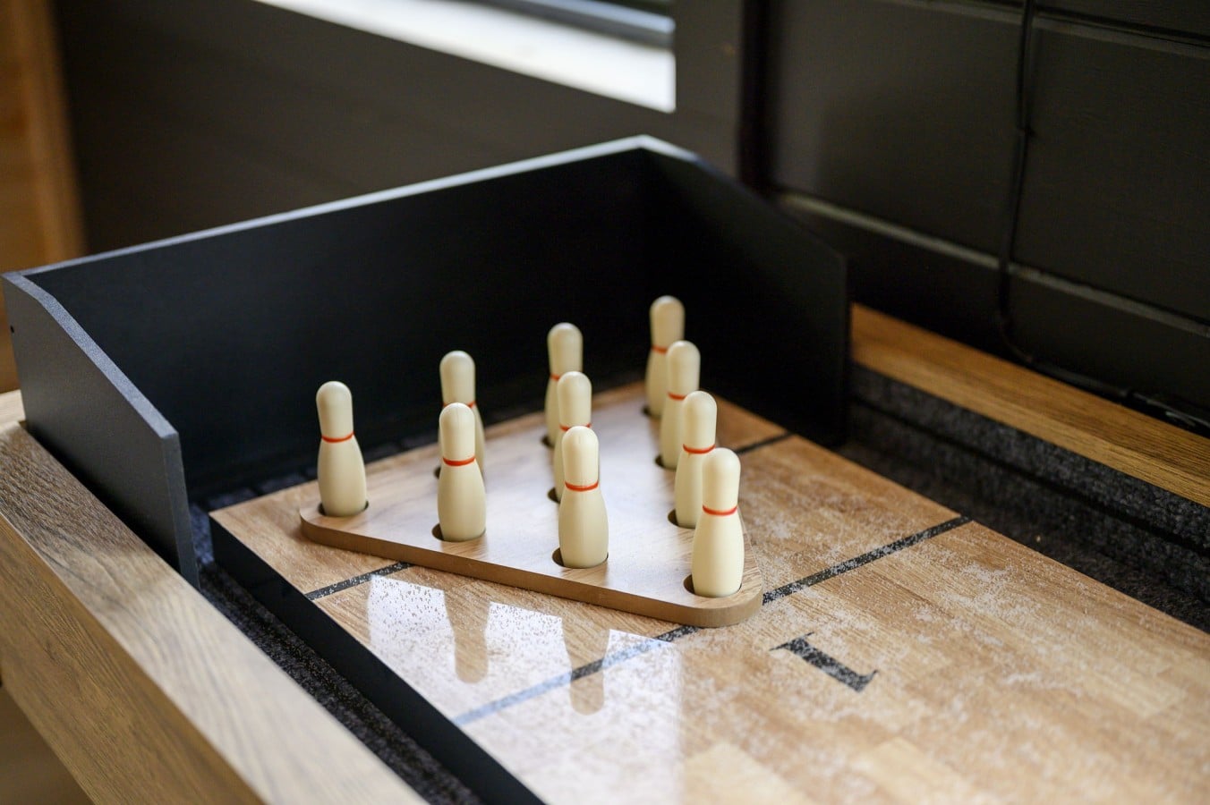 Mini bowling on the shuffleboard table keeps the fun going long after the sun goes down.