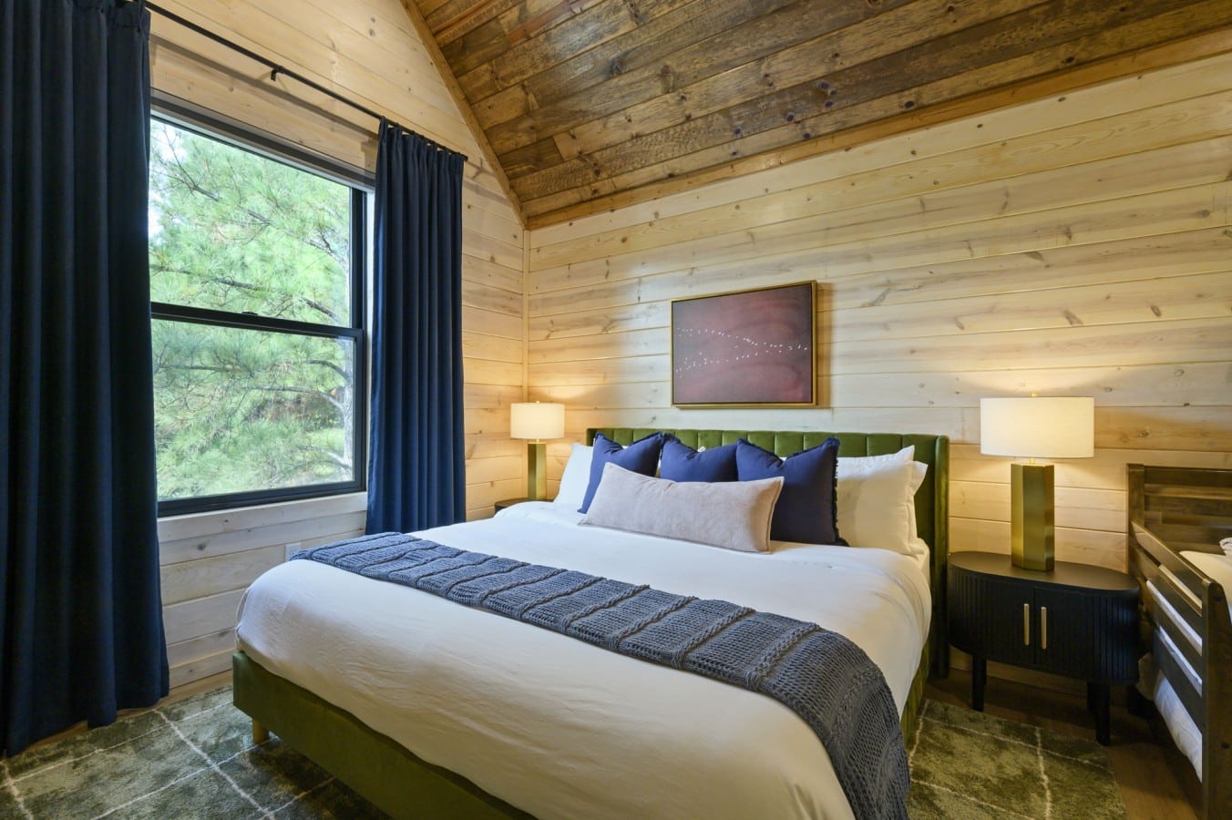 Pine trees frame your king-size morning as cathedral ceilings fill the room with calm.