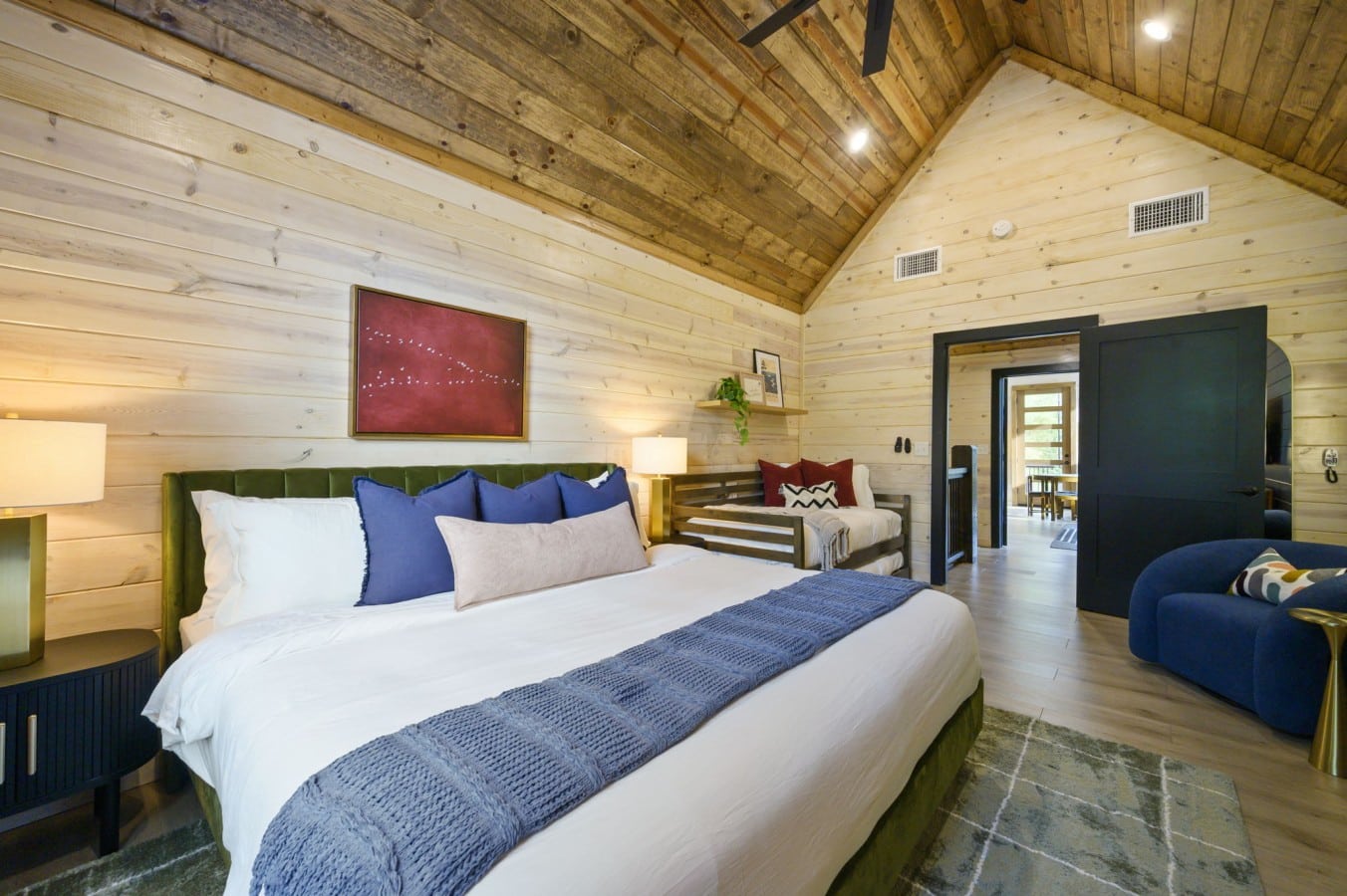 Bold art, warm lamplight, and a velvet king — falling asleep here is effortless.