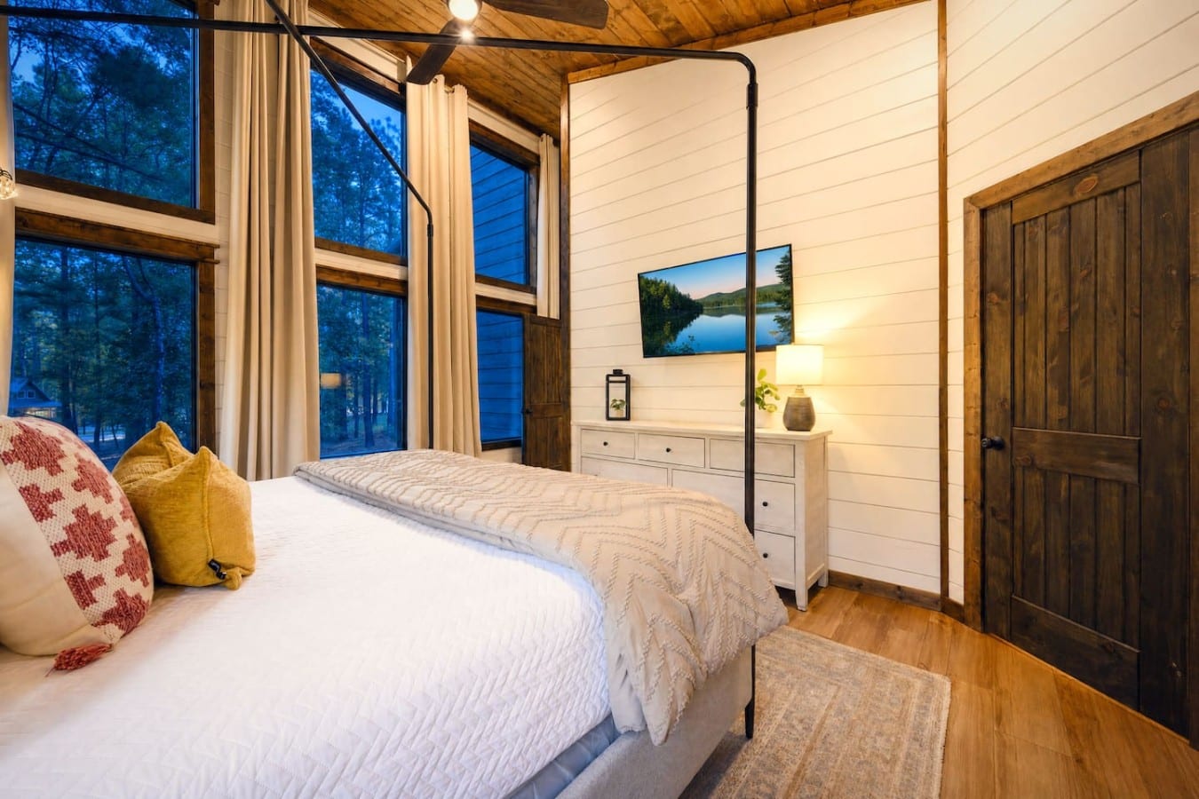 Wake up to forest twilight framed perfectly by your four-poster bedroom windows.