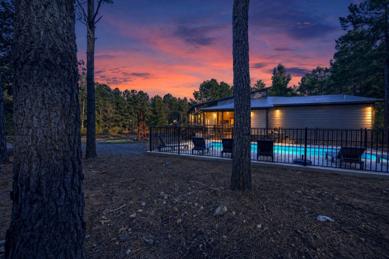 Glimpse the glowing pool through the pines and feel the vacation excitement build.