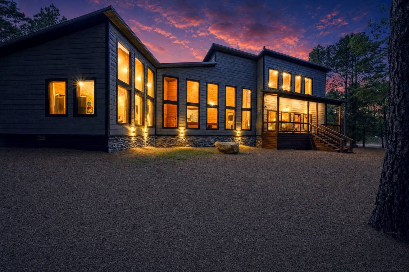 Uplighting and amber glow make arriving at this cabin feel like a five-star moment.