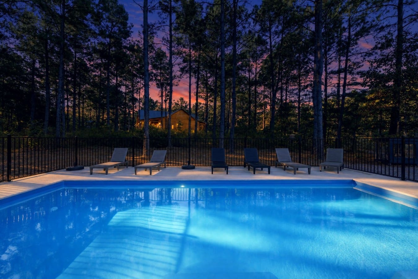 Amber skies, pine silhouettes, and a glowing pool — evenings here are truly unforgettable.