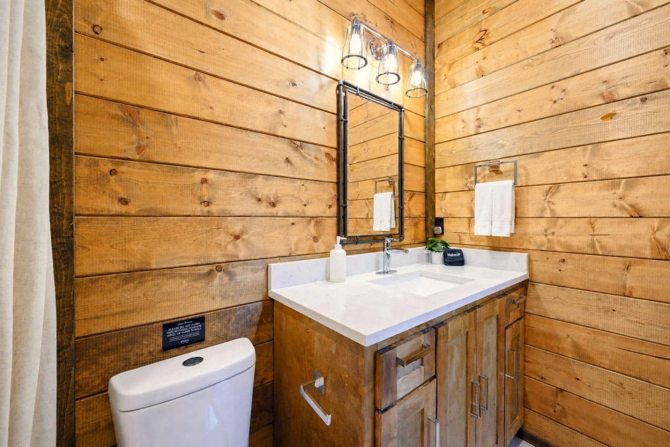 Rustic cabin charm meets modern style in this beautifully designed bathroom.