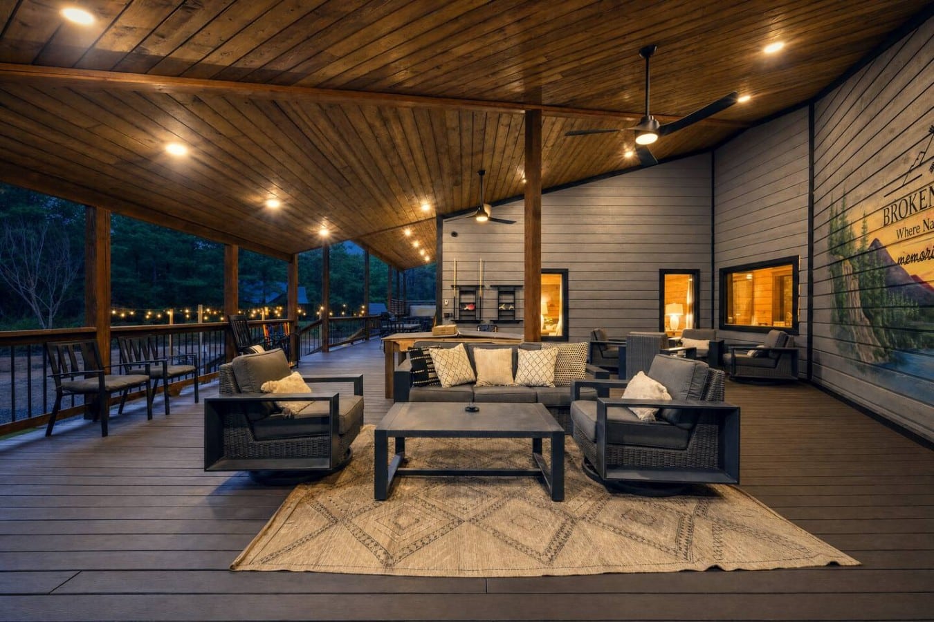 String lights, ceiling fans, and forest views make this deck impossible to leave.