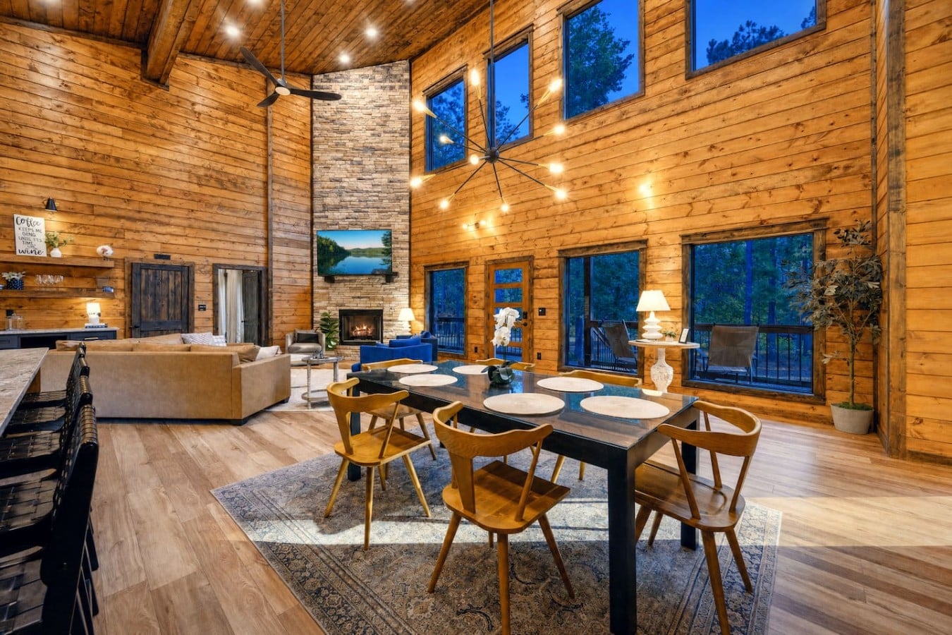 Vaulted ceilings, a stone fireplace, and a chandelier — this great room is unforgettable.