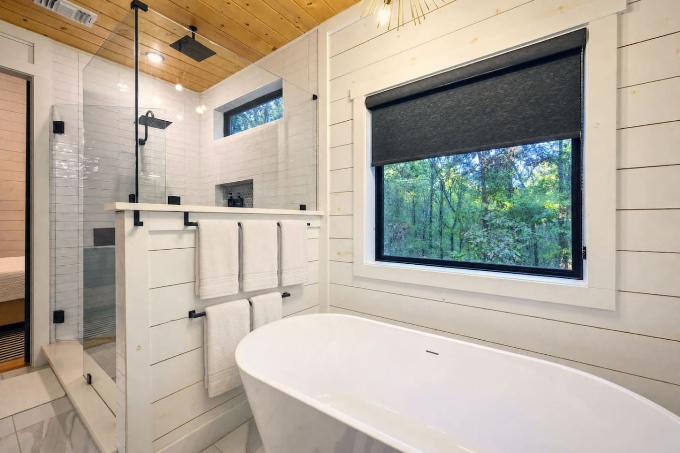 Soak in a freestanding tub with treetop views, then step into a rain shower to finish.