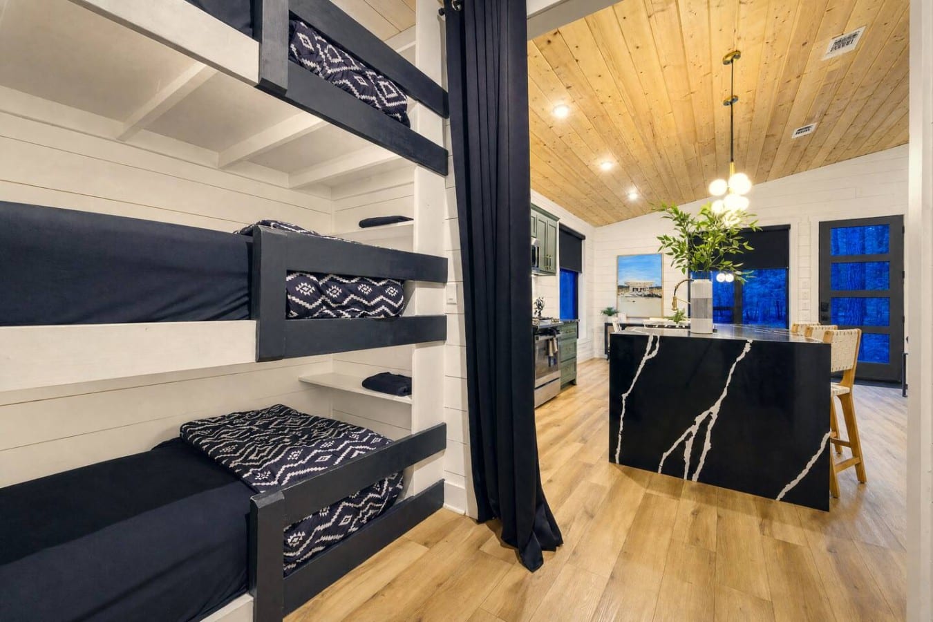 Kids get their own bunk hideaway while the stunning open kitchen stays steps away.