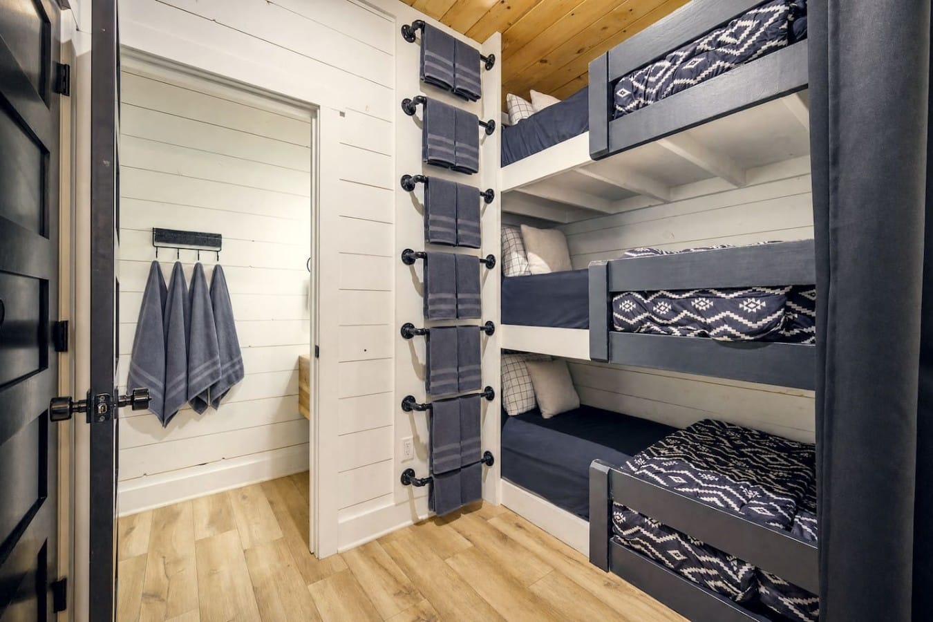 Triple bunks and fun geometric bedding make this the room kids will fight over—in the best way.