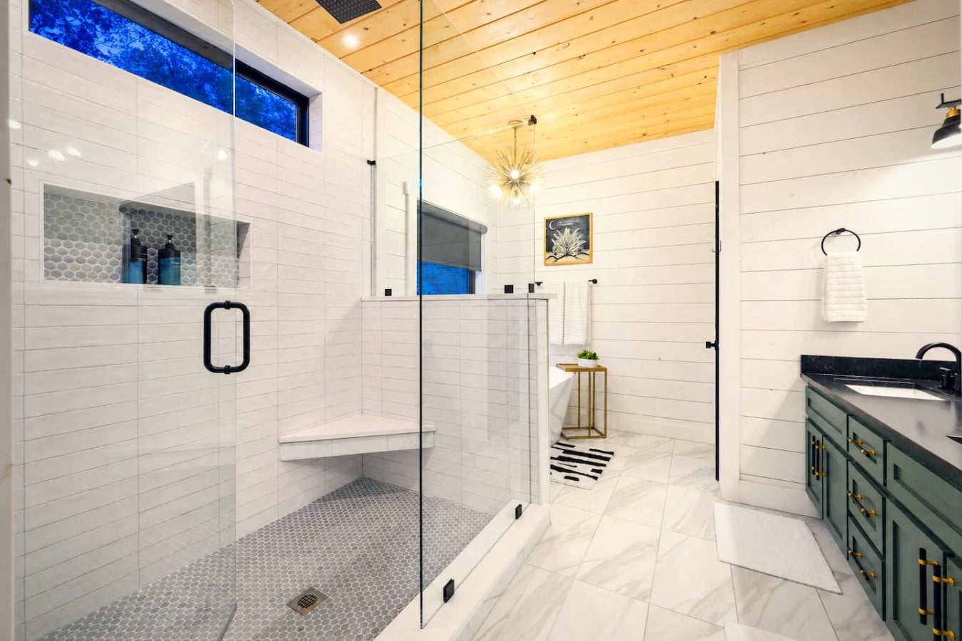 Choose between a rainfall shower or a freestanding soaking tub in this stunning master bath.