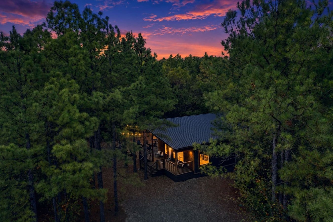 Nestled in a sea of pines, your glowing cabin looks like something out of a dream.