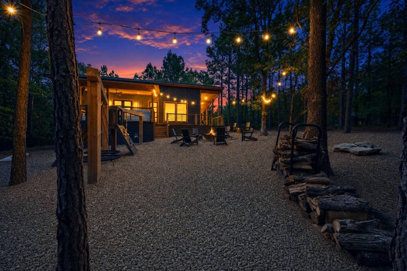 Step outside to a glowing fire pit with Adirondack chairs and a sky full of color.