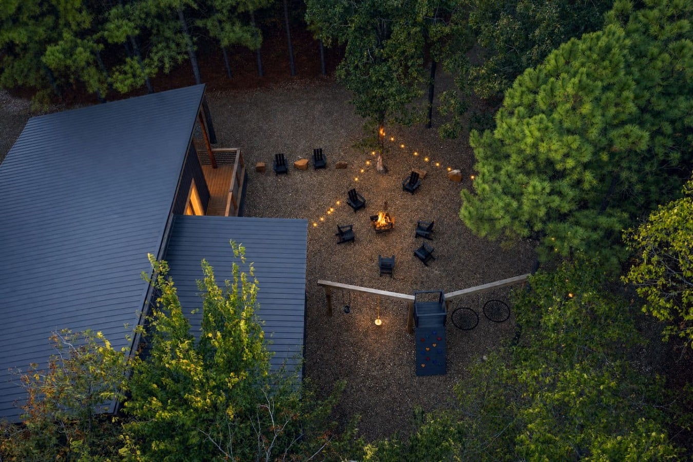 From the air, the glow of fire and string lights reveals a backyard built for memories.