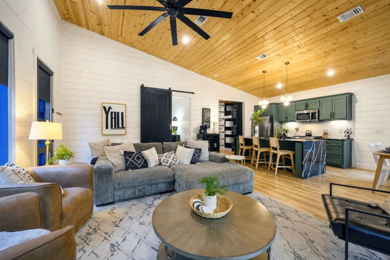 Sink into the plush sectional and unwind beneath soaring wood-beamed ceilings.